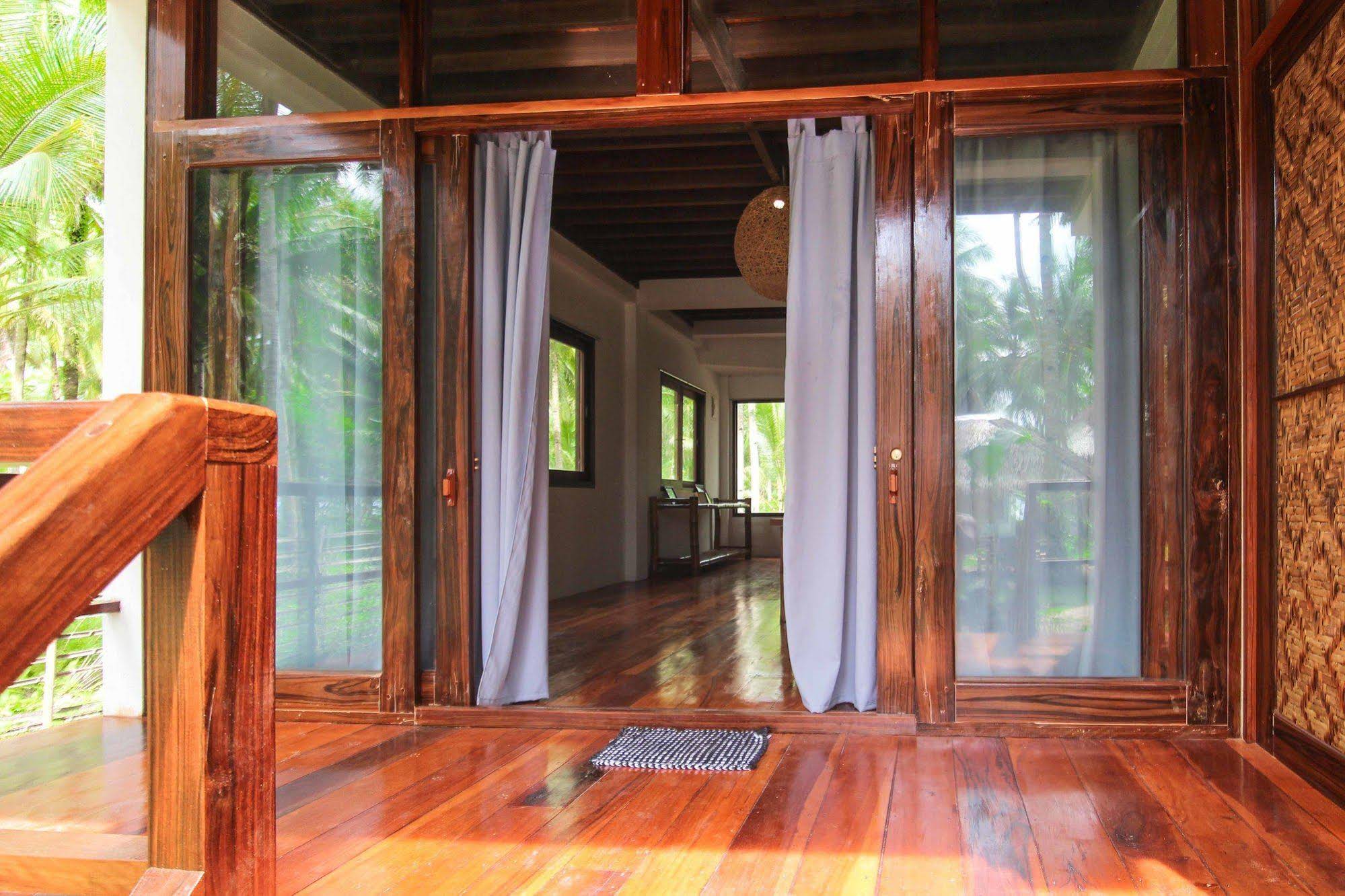 Surfing Carabao Beach Houses